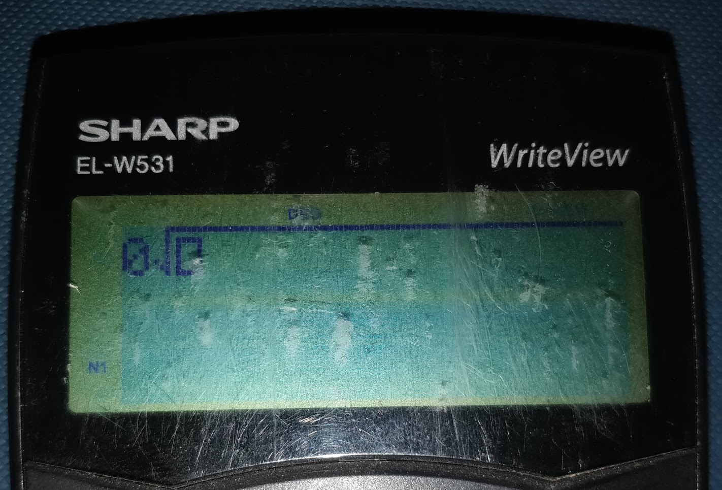 A photo of a calculator. It is showing '0, square root, box' however the bar of the square root that extends over what should be square rooted extends off the right side of the display.